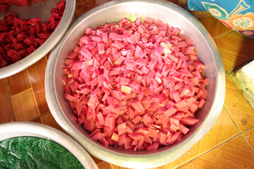 pink and red coconut jelly place them in a large stainless steel bowl.