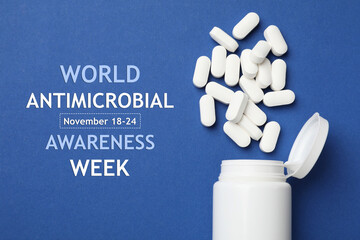 World antimicrobial awareness week. Bottle and scattered pills on blue background, top view