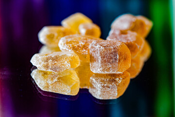 Detail brown sugar rock candy kandis on a neutral background