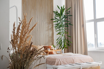 Cozy bedroom with natural decor and large window providing ample light