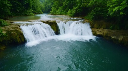 Fototapeta premium Serene Tropical Waterfall in the Heart of a Lush Green Forest Landscape