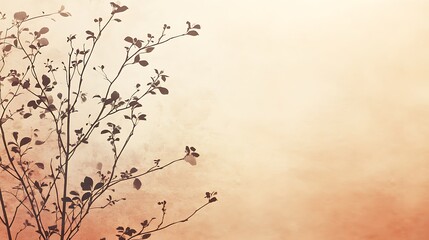 Silhouetted Branches with Delicate Leaves Against a Warm Background