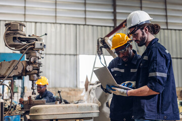 Fototapeta premium Workers Factory or Engineering work at factory site check up machine or products in site. Foreman or Technician checking Material or Machine on Plant. Heavy industry factory concept.