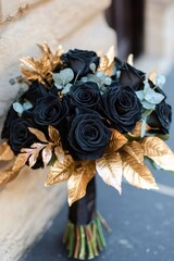 Elegant bouquet of black roses and golden leaves, perfect for a sophisticated and unique wedding or event