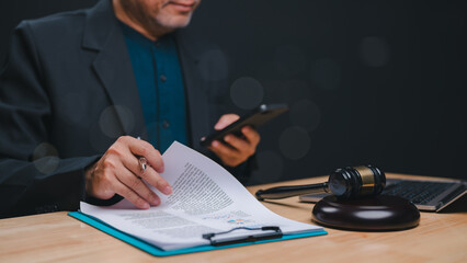 Legal Consultation in Progress, Focused professional reviews legal documents while engaging with...