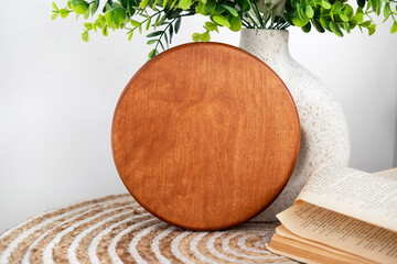 Wooden serving tray on a rustic table with a plant and book