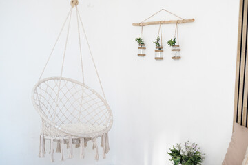 Cozy hanging chair with greenery decor in a bright indoor space