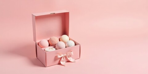 Pink gift box with assorted pastel bath bombs, tied with a delicate satin ribbon, perfect for a relaxing self-care gift