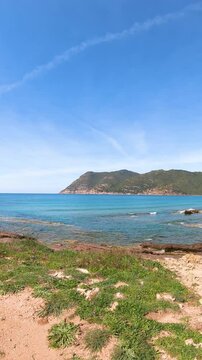 Vertical video of Porto Ferro shore on a sunny day. Sardinia, Italy