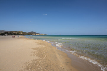 The beautiful beach of Su Giudeu in the south of Sardinia with transparent and turquoise water and a small island in front of the bay