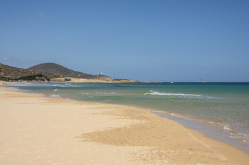 The beautiful beach of Su Giudeu in the south of Sardinia with transparent and turquoise water and a small island in front of the bay