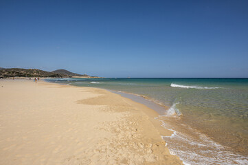 The beautiful beach of Su Giudeu in the south of Sardinia with transparent and turquoise water and a small island in front of the bay