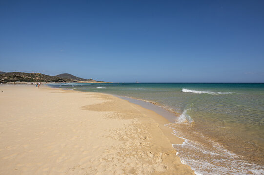 The beautiful beach of Su Giudeu in the south of Sardinia with transparent and turquoise water and a small island in front of the bay