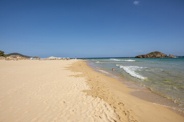 The beautiful beach of Su Giudeu in the south of Sardinia with transparent and turquoise water and a small island in front of the bay