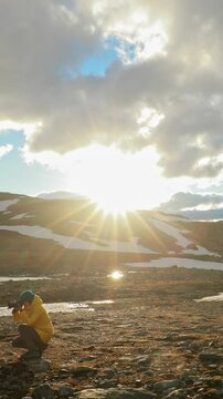 Aurlandsfjellet, Norway - June 13, 2019: Young Woman Tourist Traveler Photographer Taking Pictures Photos Near Parked Renault Duster Car. Aurlandsfjellet Scenic Route Road
