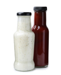 Different delicious sauces in glass bottles isolated on white