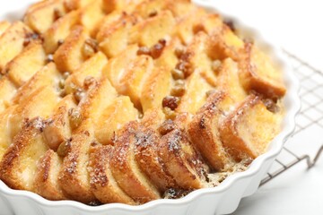 Delicious bread pudding with raisins on white table, closeup