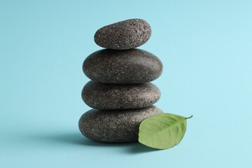 Stack of rocks on light blue background. Harmony and life balance