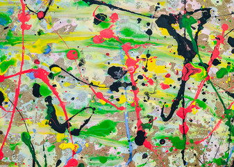Fototapeta premium Abstract light bright background made of acrylic and latex paint. Green, red, yellow and black spots of flowing splattered paint. Abstract expressionism.