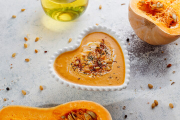 Traditional autumn butternut squash soup with seeds.