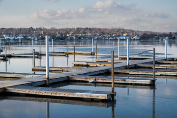 Photograph of an empty marina in the winter with a town in the background