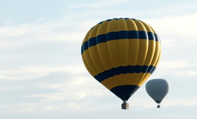 Fototapeta premium Yellow hot-air balloon against the blue sky background air balloon flight space for text balloon background balloon background party holiday celebration decoration