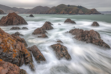 Waves crash on rocky ocean shore