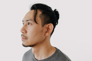 Close up head shot face of man with man bun hair style isolate on white.