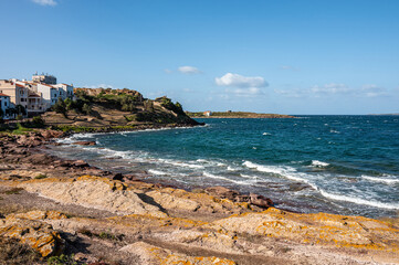 Coastline of Sant'Antioco Island with high red cliffs and rough sea