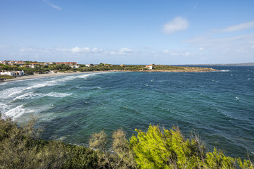 Coastline of Sant'Antioco Island with high red cliffs and rough sea