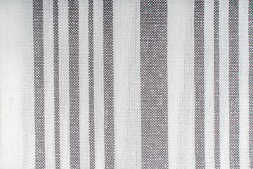 Fototapeta premium Background with white gray stripe fabric texture. A strict and laconic background with stripes of different widths.