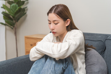 Naklejka premium Sad, unhappy. Alone asian young woman, girl hand cover face thinking about problem, difficulty, feeling failure and exhausted, suffering from loneliness, grief sorrow and bad relationship or break up.