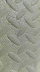 Detailed Texture of Cream-Colored Yoga Mat with Honeycomb Pattern for Foot Massage