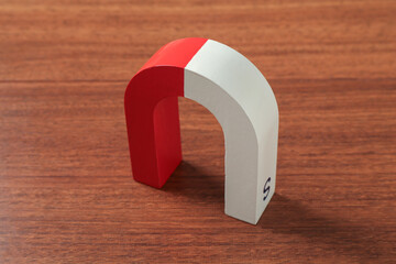 One color horseshoe magnet on wooden table