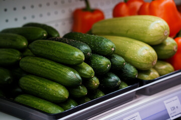 Fresh and Vibrant Assortment of Cucumbers and Zucchini in a Grocery Store Display
