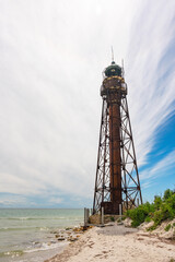 An old rusty abandoned lighthouse and a ruined building on the Dzharylhach island on the Black Sea coast