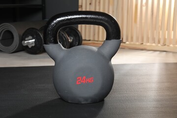 Fototapeta premium One kettlebell on mat in gym, closeup