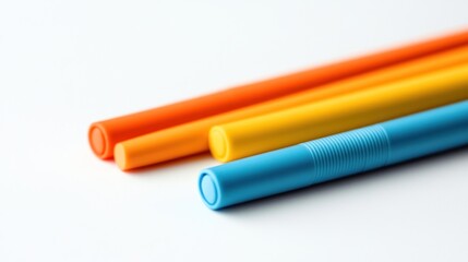 Fototapeta premium Three colorful cylindrical objects on white background.