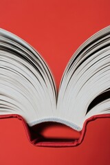 A book lying open on a red surface, perfect for editorial or design use