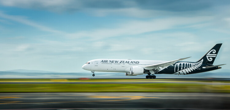 Auckland, New Zealand: December 18 2020 - An Air New Zealand flight taking off with front wheels off the ground at Auckland domestic airport. Image captured using camera panning technique.