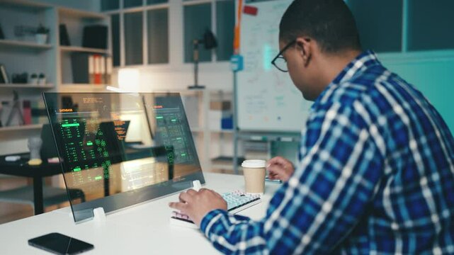 Male programmer troubleshoots bugs in a program on a futuristic computer screen