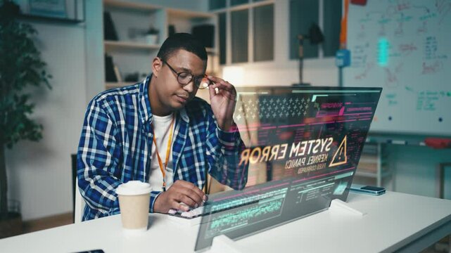 IT engineer struggles to locate an error in the code on futuristic computer