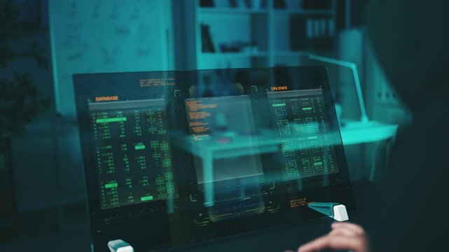 Hacker writes a ransomware program on a futuristic computer, planning an attack