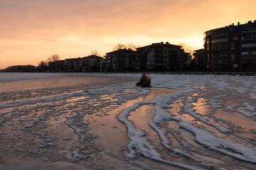 Frozen Lake Balaton at sunrise with snowy shoreline