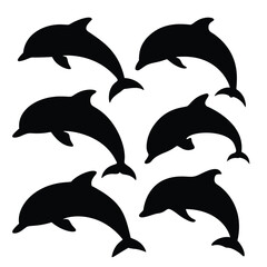 Fototapeta premium Silhouettes of playful dolphins leaping in the ocean