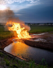 Oil Fountain Blazes Fiercely Under the Twilight Sky in an Open Field