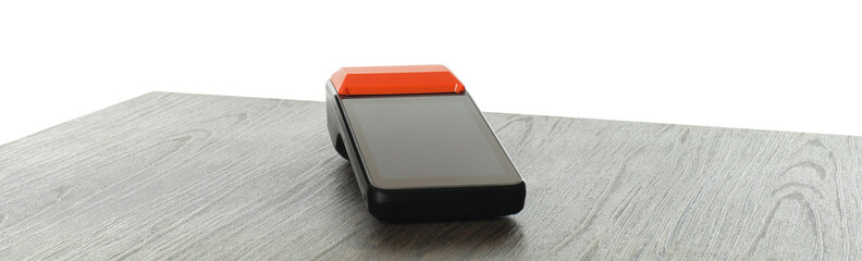 Payment terminal on wooden table against white background
