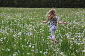 Girl Running Through Flower Field