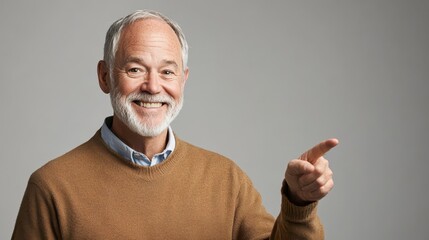 Smiling elderly man pointing, wearing brown sweater and light blue shirt