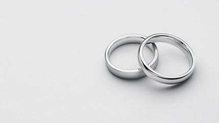 Elegant and Simple Silver Wedding Bands on a Soft Background Displaying Love and Commitment